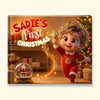 A square custom Christmas gift box or print cover featuring the text 'Sadie's First Christmas' over a festive illustrated scene. The design shows a smiling child in red pajamas holding a star, with a Christmas tree, fireplace, gifts, and a teddy bear in the background.