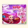 A hardcover children's book titled 'Daisy and Jack the Elf's Christmas' featuring a colorful, whimsical Christmas illustration on the cover. The cover art depicts a baby doll named Daisy in a red outfit sitting on a pink sleigh, surrounded by gifts, a gingerbread cookie, a reindeer, and a snowy castle under a purple starry sky.