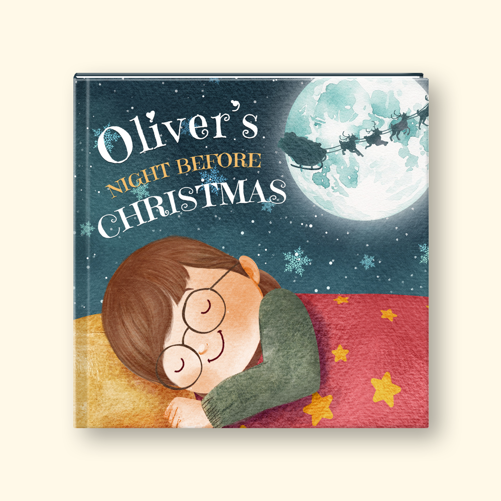 A hardcover children's book titled 'Oliver's Night Before Christmas' featuring an illustrated sleeping boy with glasses under a large full moon and Santa's sleigh.