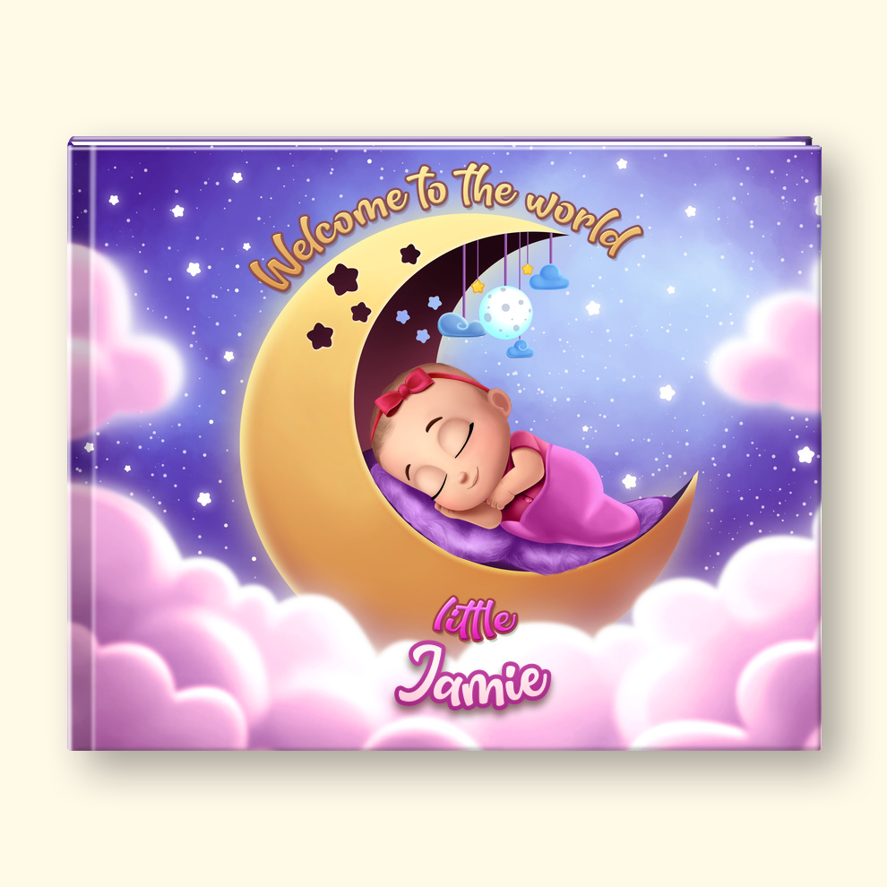 A personalized baby photo book cover shown closed on a white background, with a cartoon-style baby in a pink outfit and bow sitting in the lower right corner. The cover features a purple starry sky, pink clouds, a yellow crescent moon, a sleeping baby, and the text 'Welcome to the world' and 'little Jamie'.